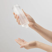Needly Daily Toner bottle held in handx